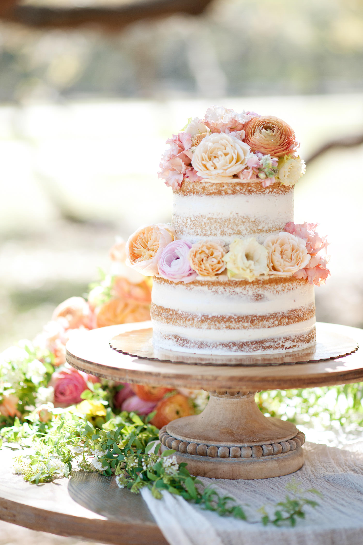 Wedding cake adorned in fresh flowers captured by Tara Whittaker Photography