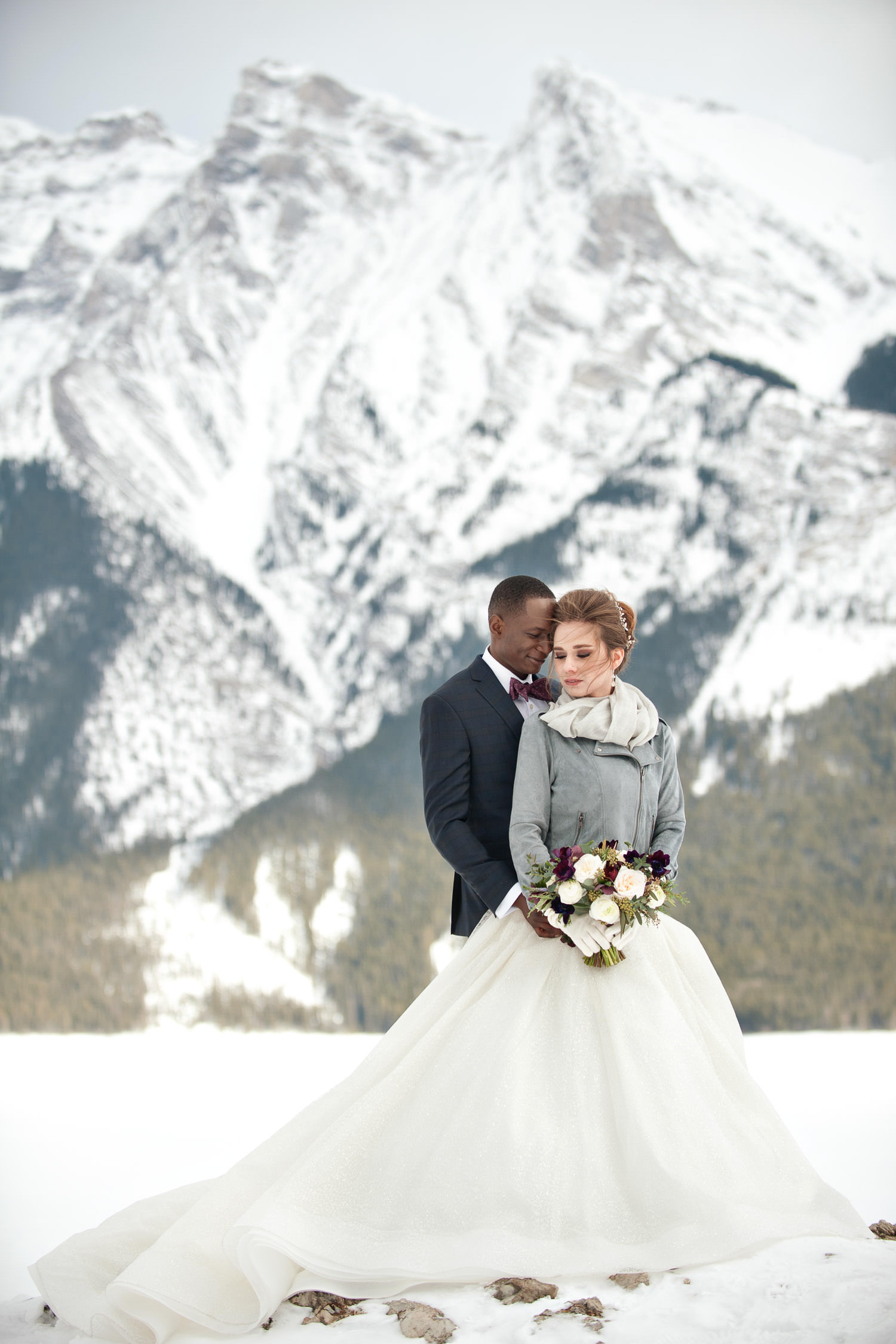 bride and groom during winter wedding photos at Lake Minnewanka captured by Tara Whittaker Photography