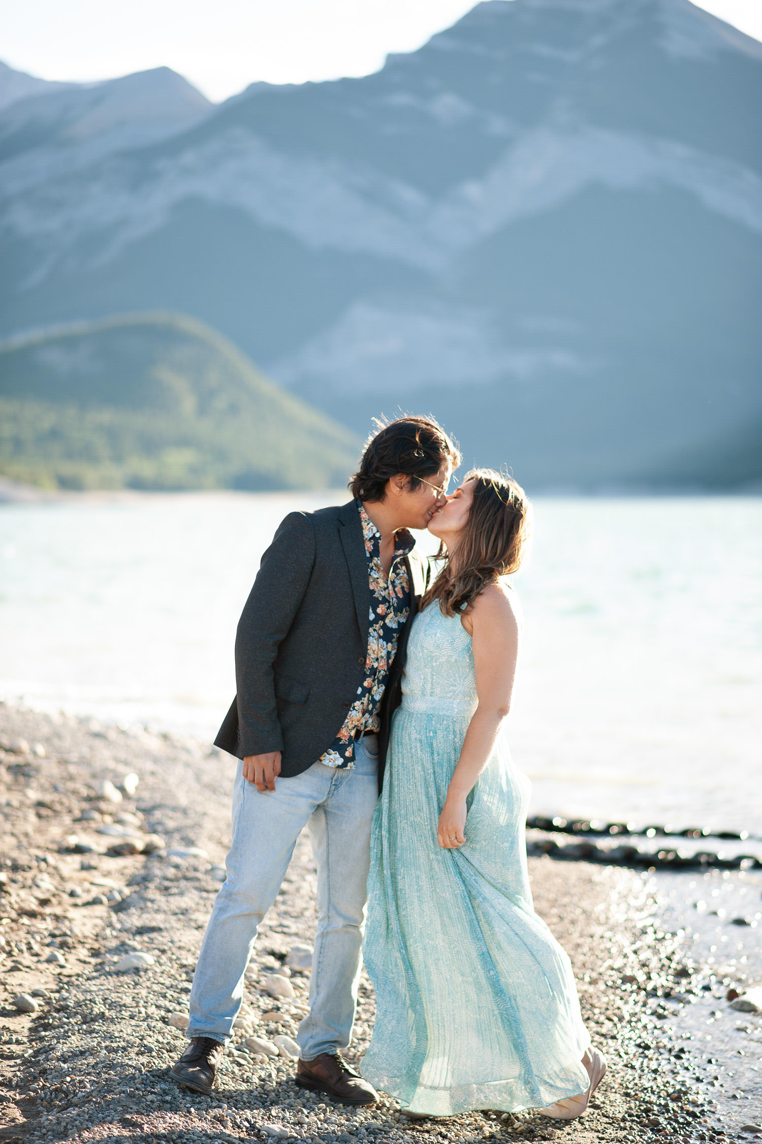 Couple kiss at Barrier Lake captured by Calgary wedding photographer Tara Whittaker
