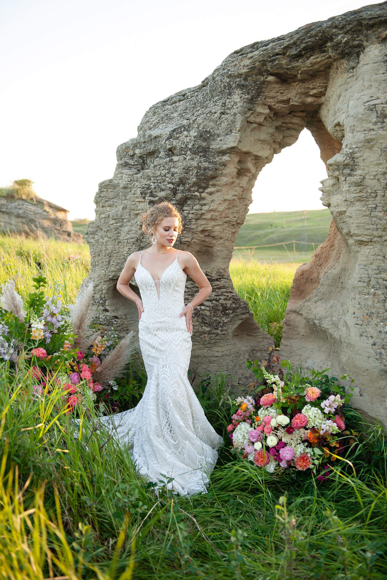 Bride stands at ceremony site captured by Tara Whittaker Photography