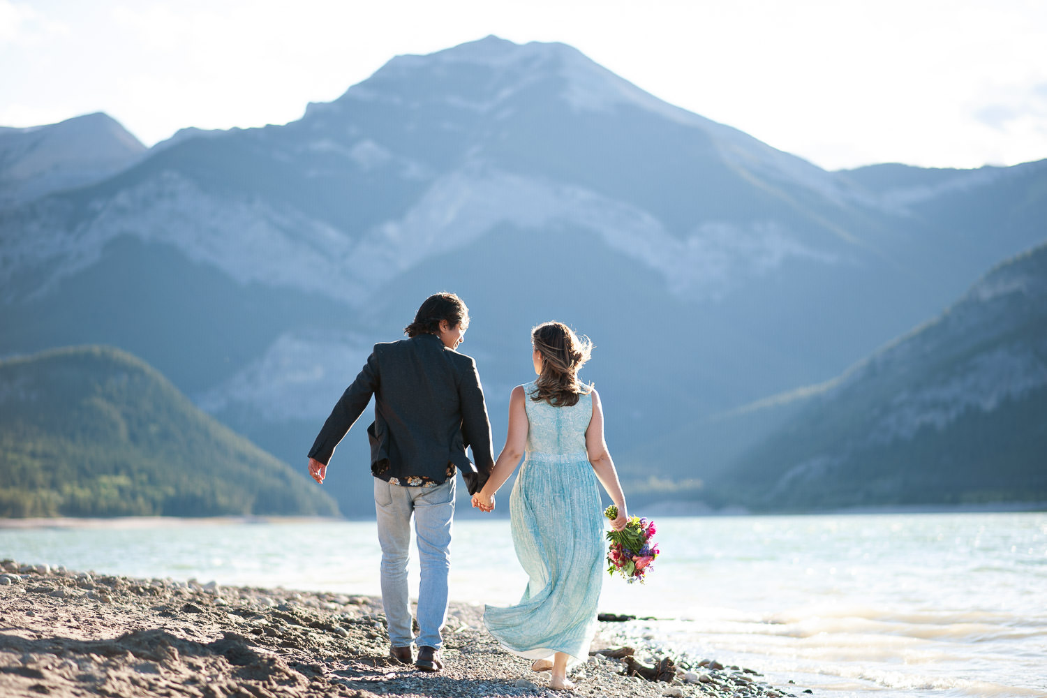 couple strolling on shore of Barrier Lake captured by Tara Whittaker Photography
