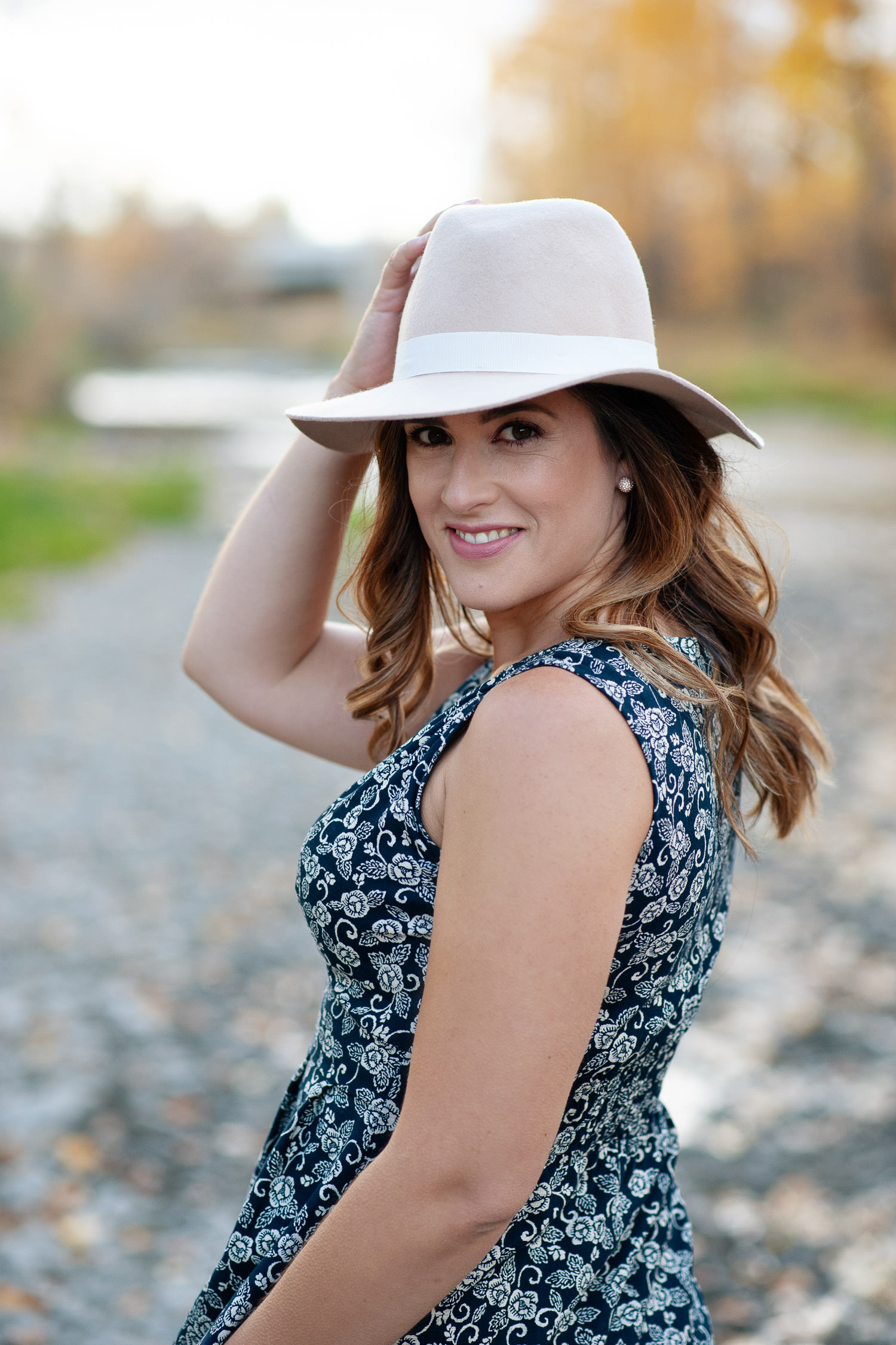 Janie wears a hat during a fall photo shoot in Fish Creek Park captured by Tara Whittaker Photography