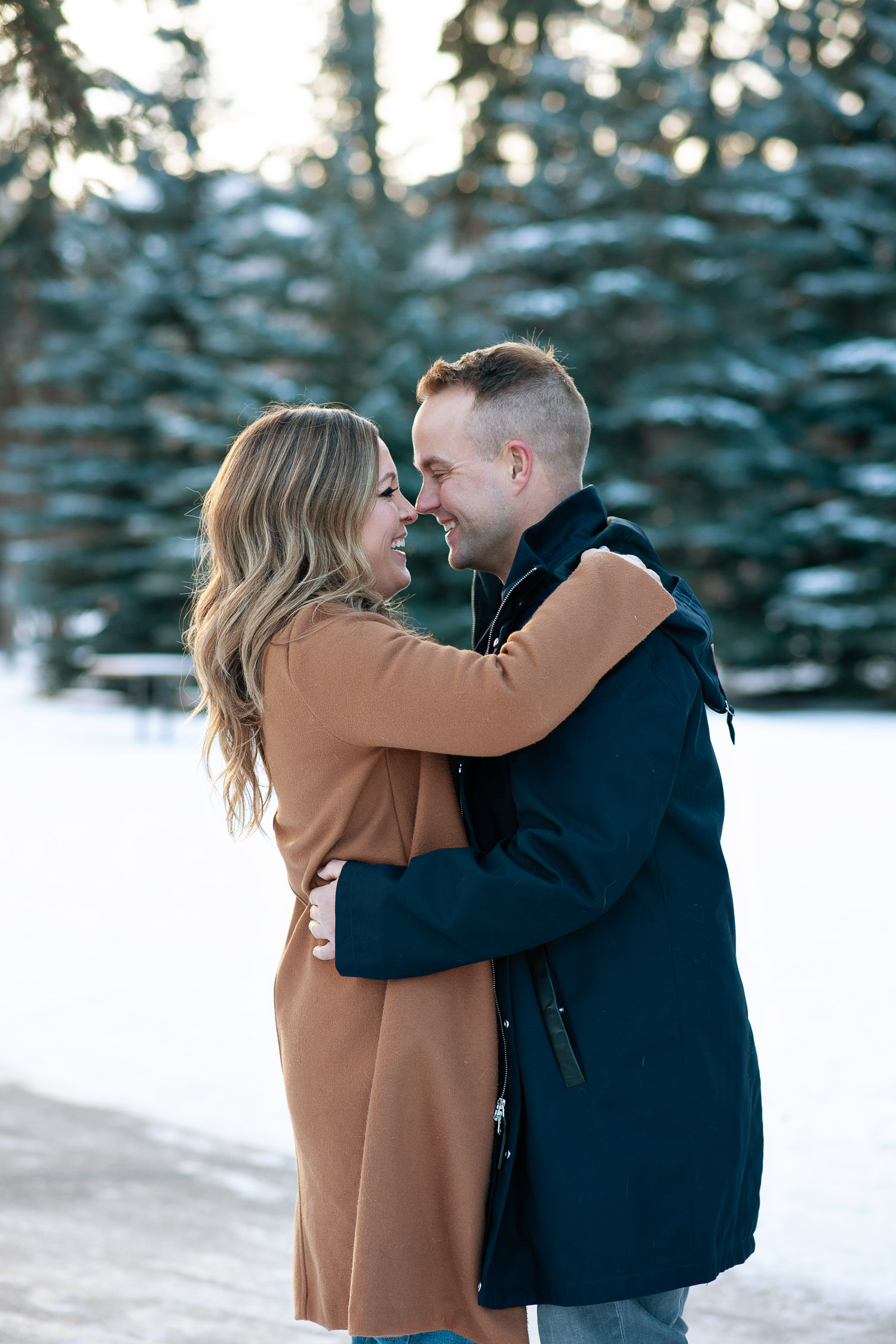 couple get cozy during winter engagement shoot with Tara Whittaker Photography