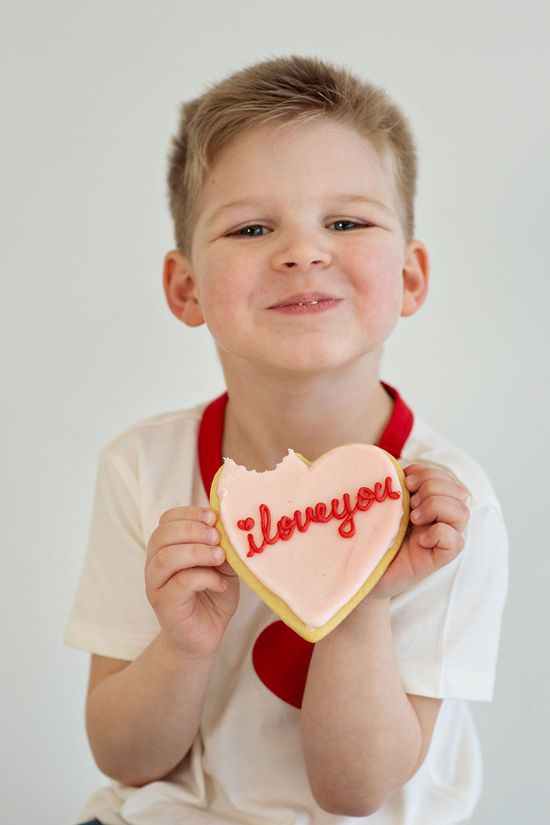 Child holding a sweetheart cookie for Valentine's Day