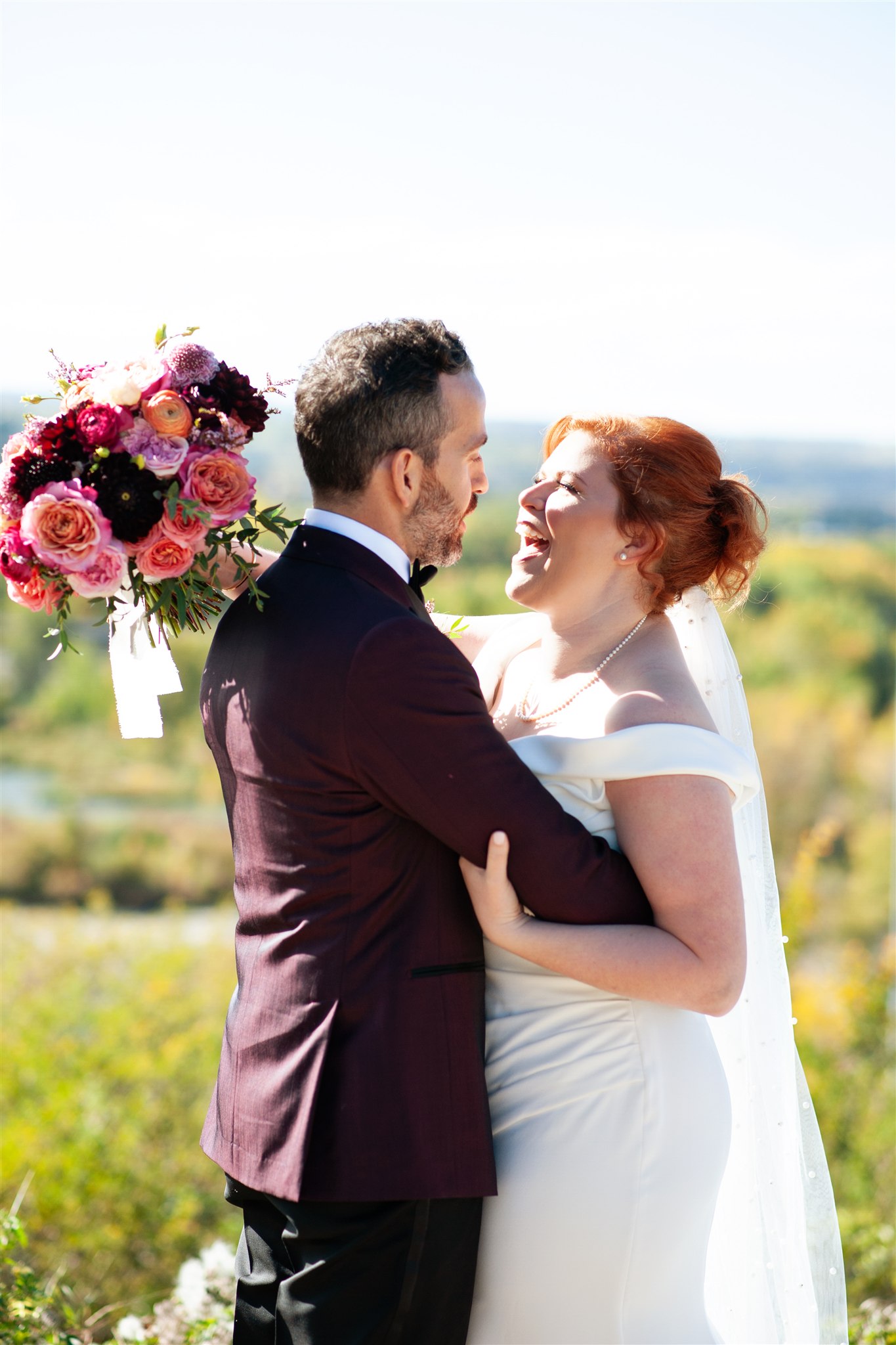 Bride and groom at Rotary Park for autumn wedding, bride holding jewel toned bouquet