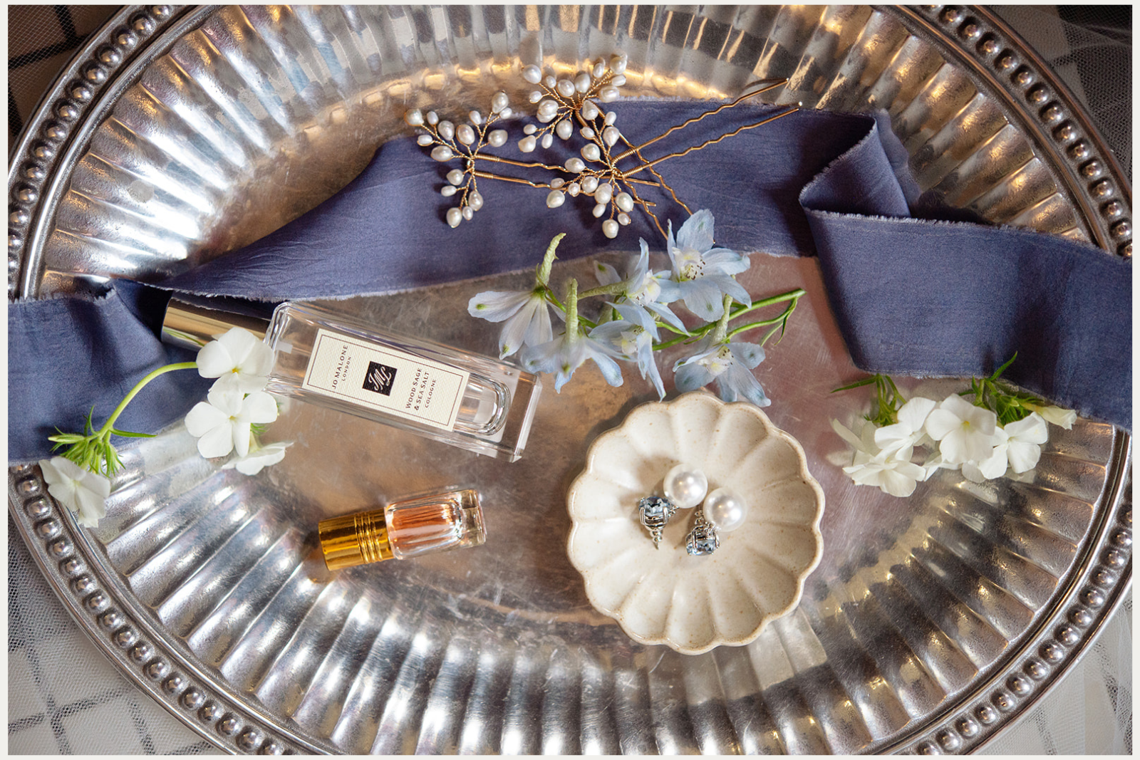 Detail photo of silver plate with wedding heirlooms and accessories